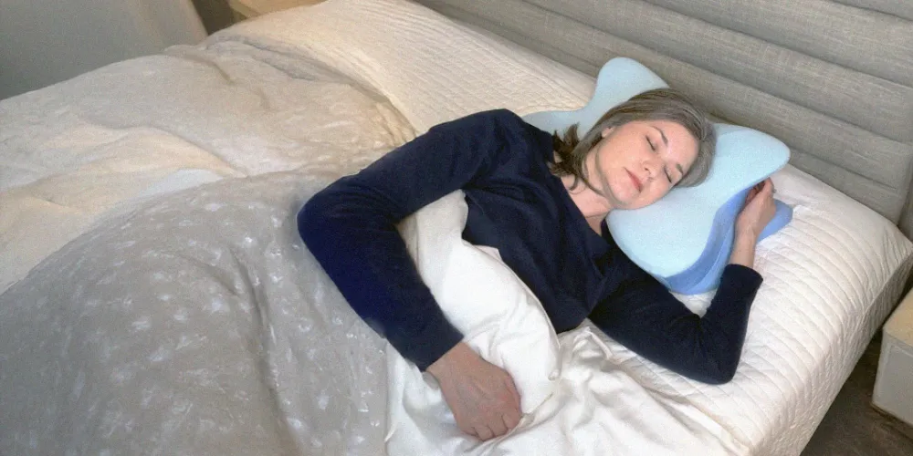 Person lying on a contoured pillow